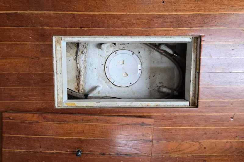 Slide: The Image of Wooden floor panel with an open hatch revealing a compartment in a 1978 Bristol 35.5. - 28