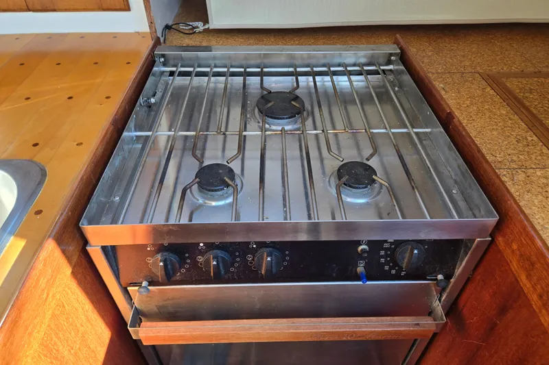Slide: The Image of 1978 Bristol 35.5 yacht kitchen with a stainless steel gas stove and oven. - 25