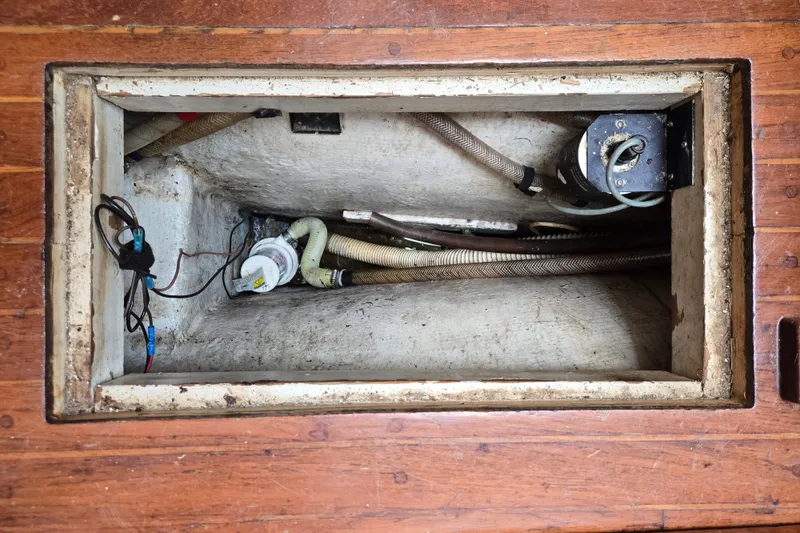 Slide: The Image of Bilge compartment of a 1978 Bristol 35.5 sailboat, showing hoses and wiring. - 29