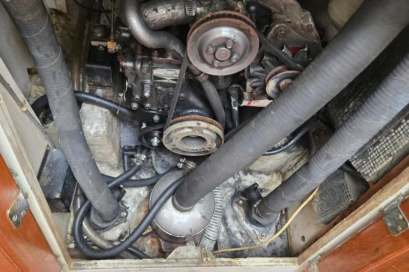 Slide: The Image of Engine compartment of a 1978 Bristol 35.5 sailboat, showcasing mechanical components and hoses. - 33