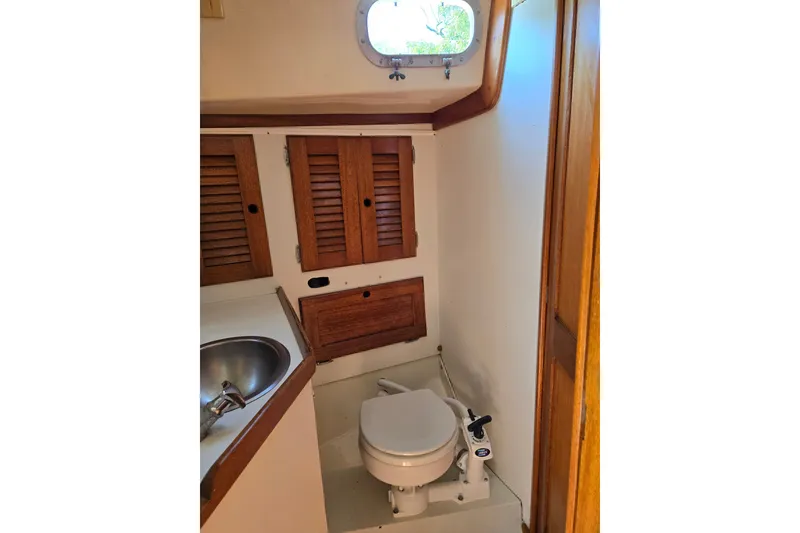 Slide: The Image of 1978 Bristol 35.5 yacht bathroom with wooden cabinets and compact toilet. - 19