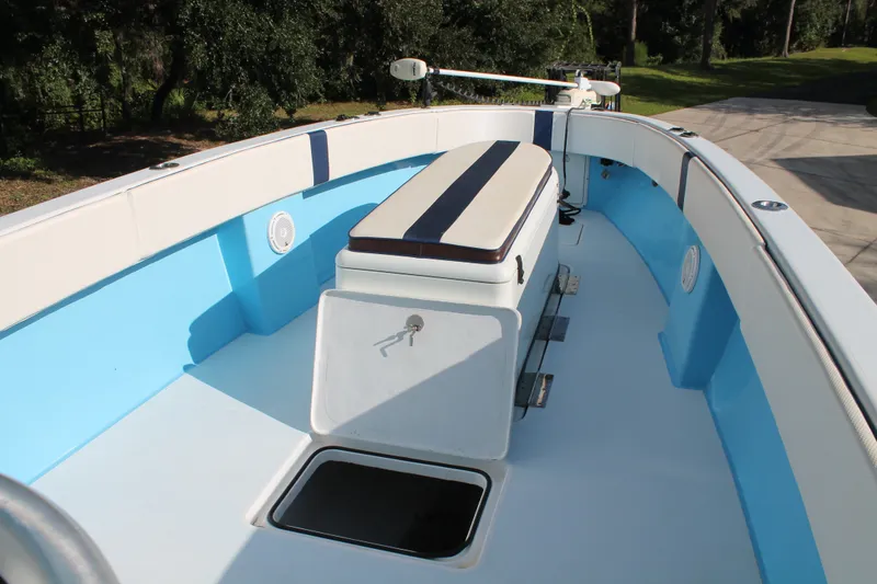 Slide: The Image of 2018 Lightning 38 Center Console boat interior with blue and white seating and storage. - 12