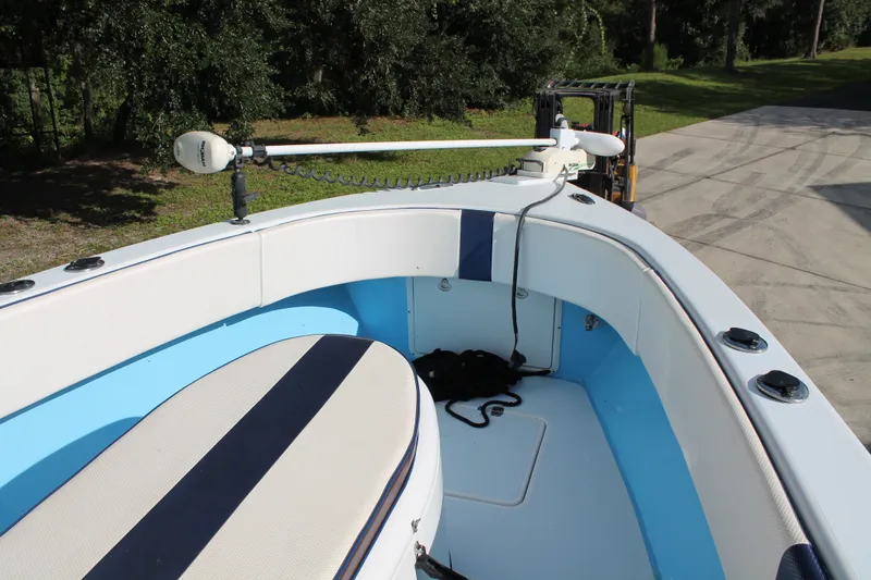 Slide: The Image of 2018 Lightning 38 Center Console boat with blue and white seating, docked outdoors. - 13