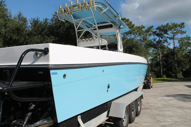 Slide: The Image of 2018 Lightning 38 Center Console boat with blue hull on a trailer, outdoors. - 4