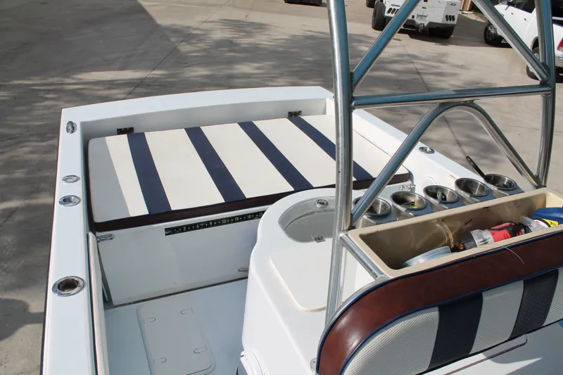 Slide: The Image of 2018 Lightning 38 Center Console boat interior with striped seating and fishing rod holders. - 15