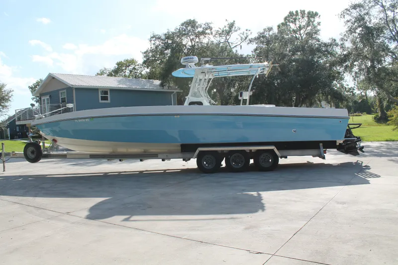 Slide: The Image of 2018 Lightning 38 Center Console boat on trailer, parked outdoors. - 1