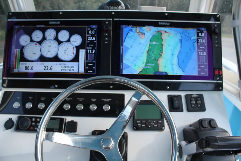 Slide: The Image of Steering wheel and navigation screens on 2018 Lightning 38 Center Console boat. - 10