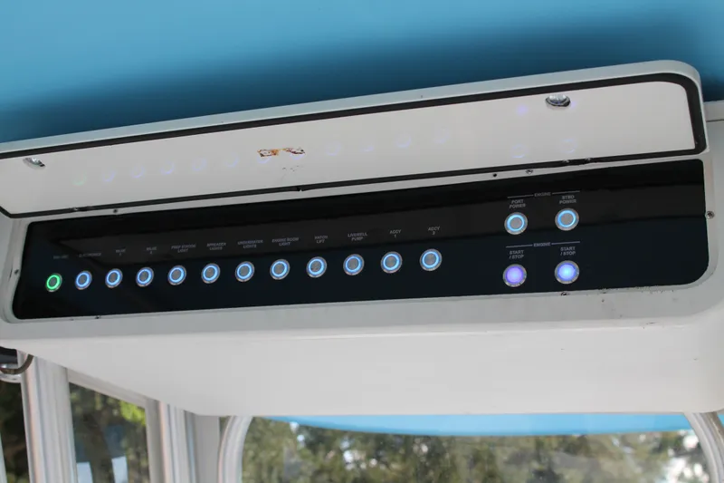Slide: The Image of Control panel of a 2018 Lightning 38 Center Console boat with illuminated buttons. - 11
