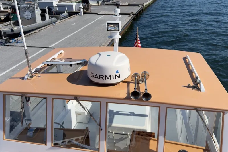 Slide: The Image of 1985 Holland 32 boat with Garmin radar, docked at marina. - 7