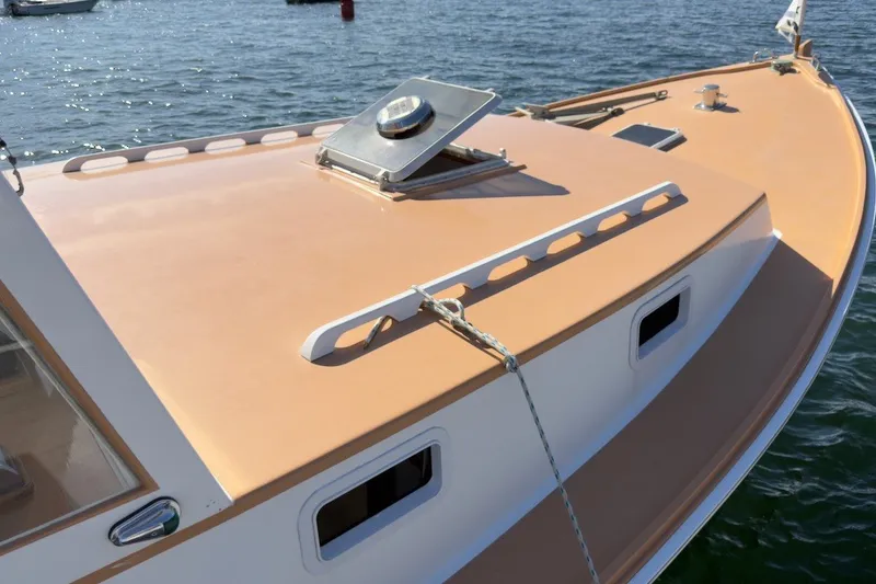Slide: The Image of 1985 Holland 32 boat deck with hatch, moored on calm water. - 5