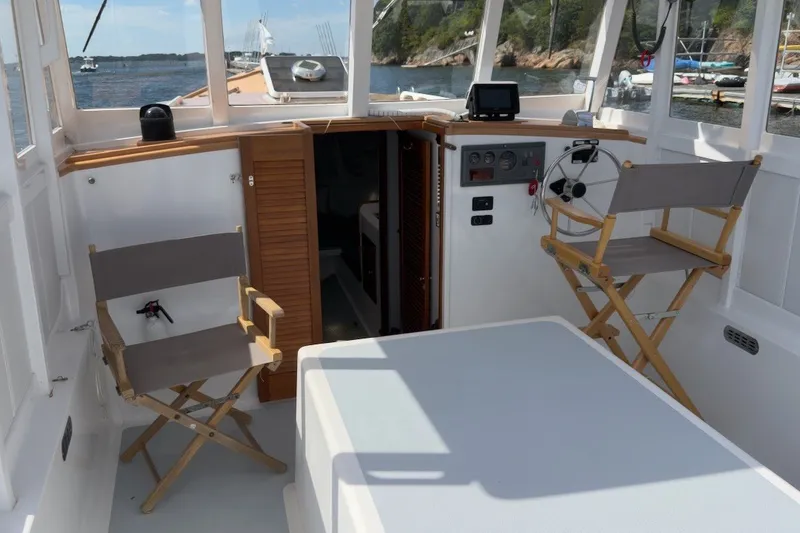 Slide: The Image of Interior of a 1985 Holland 32 boat with chairs and steering wheel. - 19