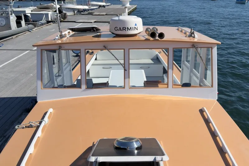 Slide: The Image of 1985 Holland 32 boat docked, featuring Garmin equipment, on a sunny day. - 6