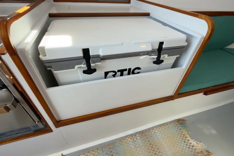 Slide: The Image of White RTIC cooler in 1985 Holland 32 boat interior with wooden trim. - 37