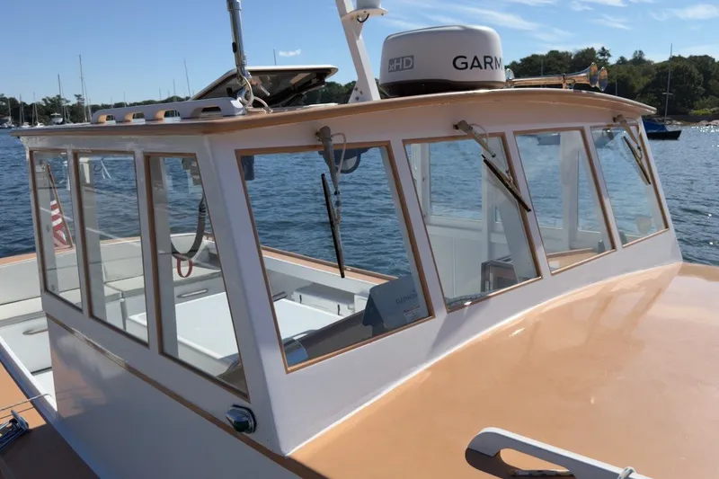 Slide: The Image of 1985 Holland 32 boat with enclosed cabin, docked on a sunny day. - 4