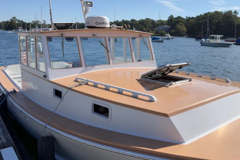 Slide: The Image of 1985 Holland 32 boat docked on a sunny day, featuring Garmin equipment. - 3