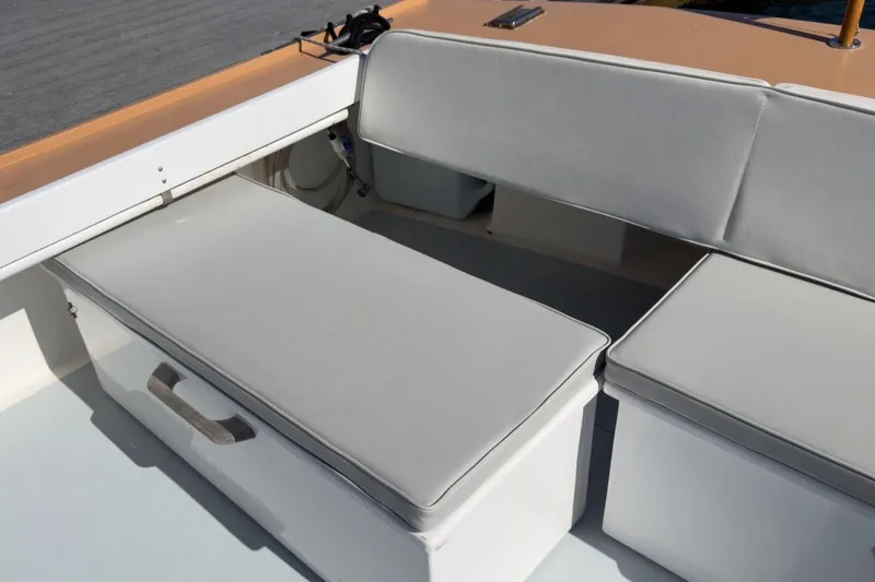 Slide: The Image of Interior seating of a 1985 Holland 32 boat with gray cushions. - 17