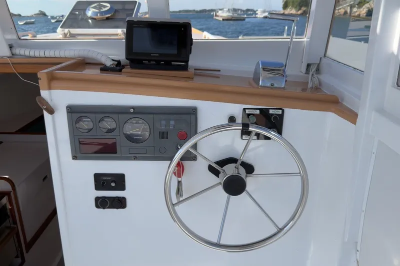 Slide: The Image of Helm of a 1985 Holland 32 boat with steering wheel and navigation instruments. - 22