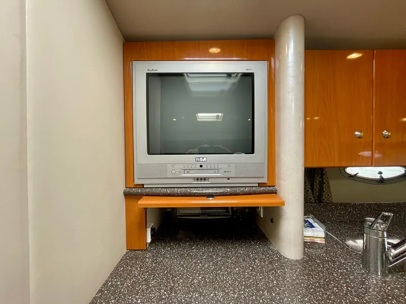 Slide: The Image of 2003 Formula 40 PC interior with vintage TV and wooden cabinetry. - 25