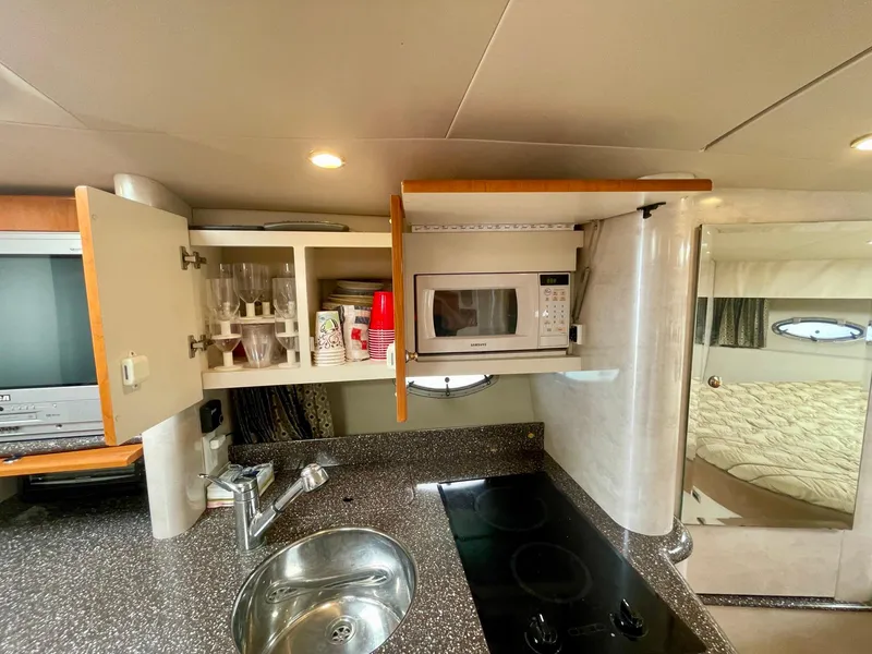 Slide: The Image of Interior of 2003 Formula 40 PC yacht kitchen with microwave, sink, and stove. - 22