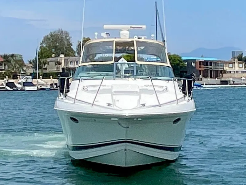 Slide: The Image of 2003 Formula 40 PC yacht cruising in a marina with waterfront homes in the background. - 1