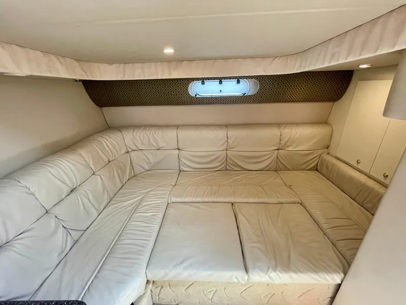 Slide: The Image of 2003 Formula 40 PC cabin interior with beige leather seating and small window. - 32