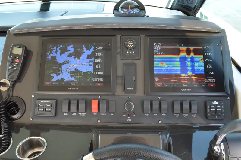 Slide: The Image of Dashboard of a 2016 Tiara Yachts Q44 with Garmin navigation displays. - 54