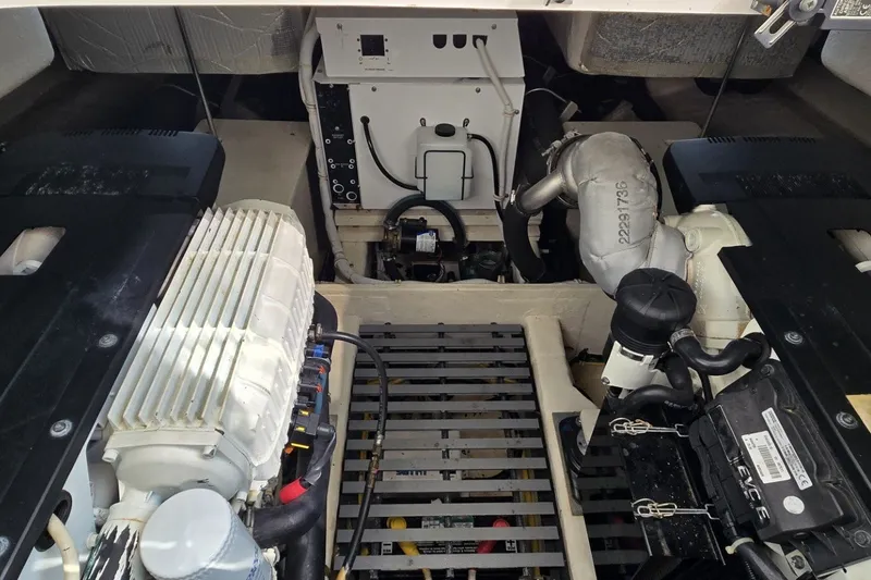 Slide: The Image of Engine compartment of a 2016 Tiara Yachts Q44, showcasing mechanical components and layout. - 73