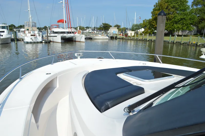 Slide: The Image of 2016 Tiara Yachts Q44 docked in a marina, featuring sleek design and comfortable seating. - 36