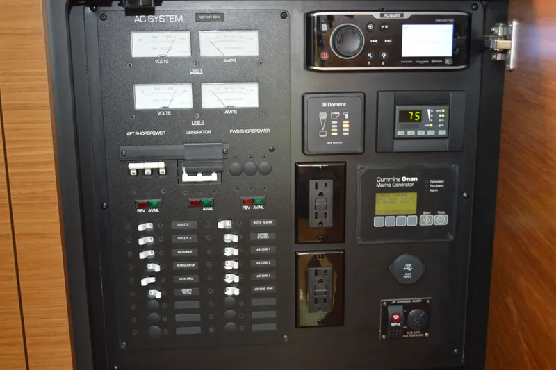 Slide: The Image of Electrical control panel on a 2016 Tiara Yachts Q44, featuring various switches and outlets. - 72