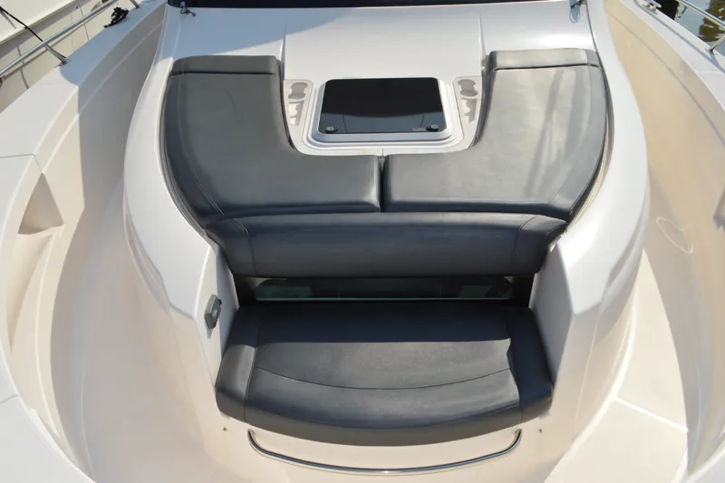 Slide: The Image of 2016 Tiara Yachts Q44 boat seating area with sleek black cushions. - 35