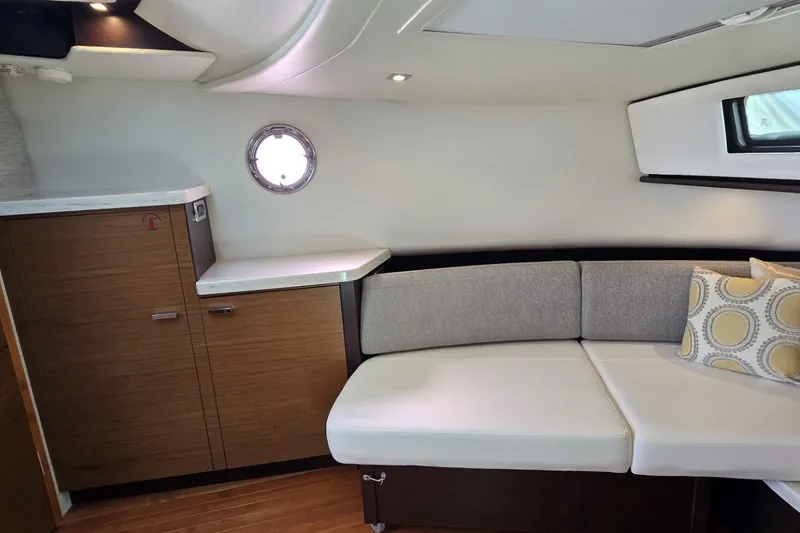 Slide: The Image of 2016 Tiara Yachts Q44 interior with modern seating and wooden cabinetry. - 64