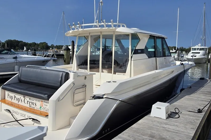 Slide: The Image of 2016 Tiara Yachts Q44 docked, featuring sleek design and spacious seating. - 18