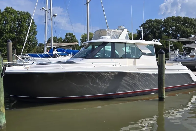 The Image of A 2016 Tiara Yachts Q44 docked, featuring a sleek design and spacious cabin. - 0