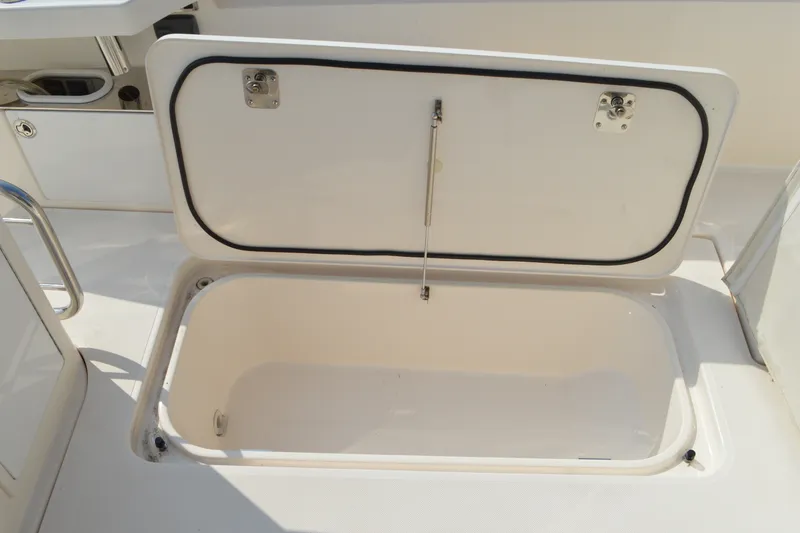 Slide: The Image of Open storage compartment on a 2016 Tiara Yachts Q44 boat deck. - 24