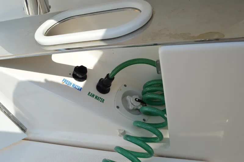 Slide: The Image of Fresh and raw water connections on 2016 Tiara Yachts Q44 with green hose. - 26