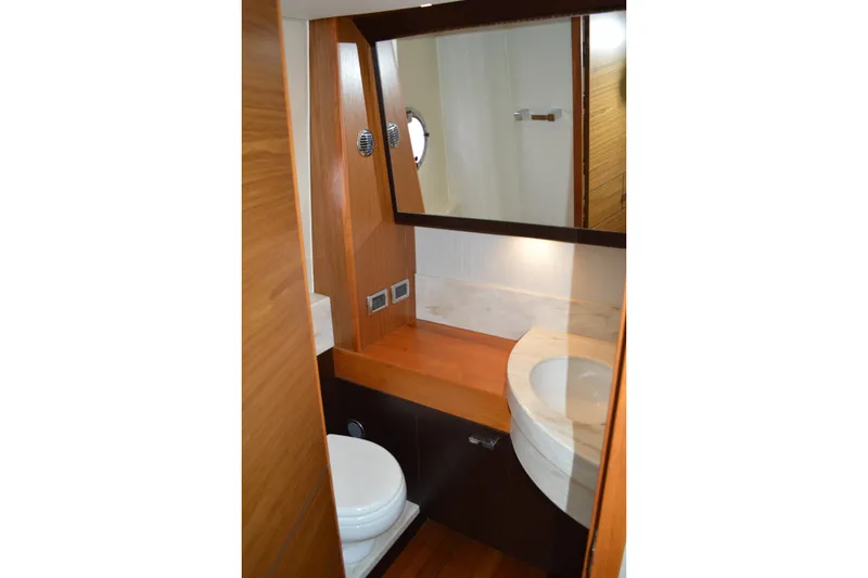 Slide: The Image of Luxurious bathroom interior of 2016 Tiara Yachts Q44, featuring wood accents and modern fixtures. - 66