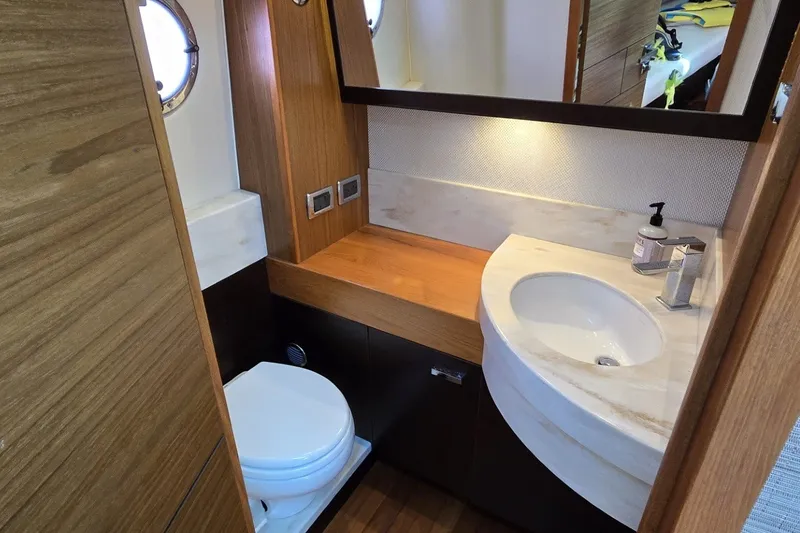 Slide: The Image of Luxurious 2016 Tiara Yachts Q44 bathroom with modern sink and wooden accents. - 67