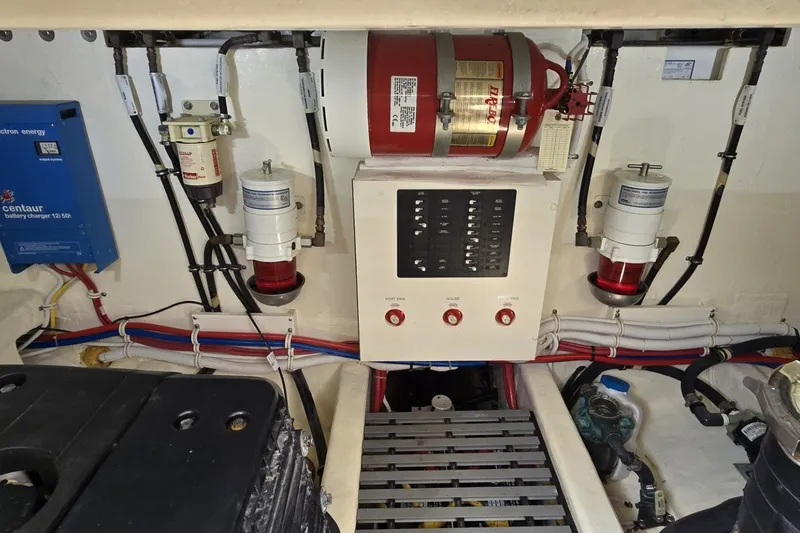 Slide: The Image of Engine room of 2016 Tiara Yachts Q44 with electrical panel and fire suppression system. - 76