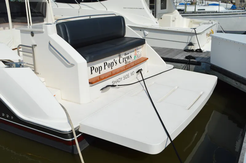 Slide: The Image of 2016 Tiara Yachts Q44 docked, featuring "Pop Pop's Crews" signage, Shady Side, MD. - 17