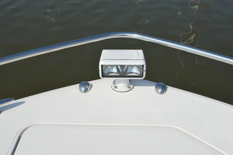 Slide: The Image of Bow of 2016 Tiara Yachts Q44 with spotlight and railing over water. - 40