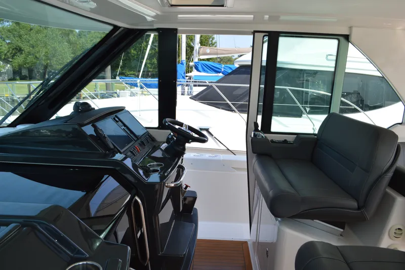 Slide: The Image of 2016 Tiara Yachts Q44 interior with sleek helm and comfortable seating. - 50