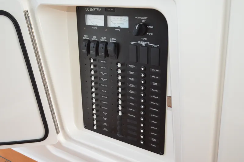 Slide: The Image of 2016 Tiara Yachts Q44 DC system panel with switches and meters. - 70