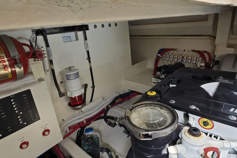 Slide: The Image of Engine room of 2016 Tiara Yachts Q44, showcasing mechanical components and wiring. - 78