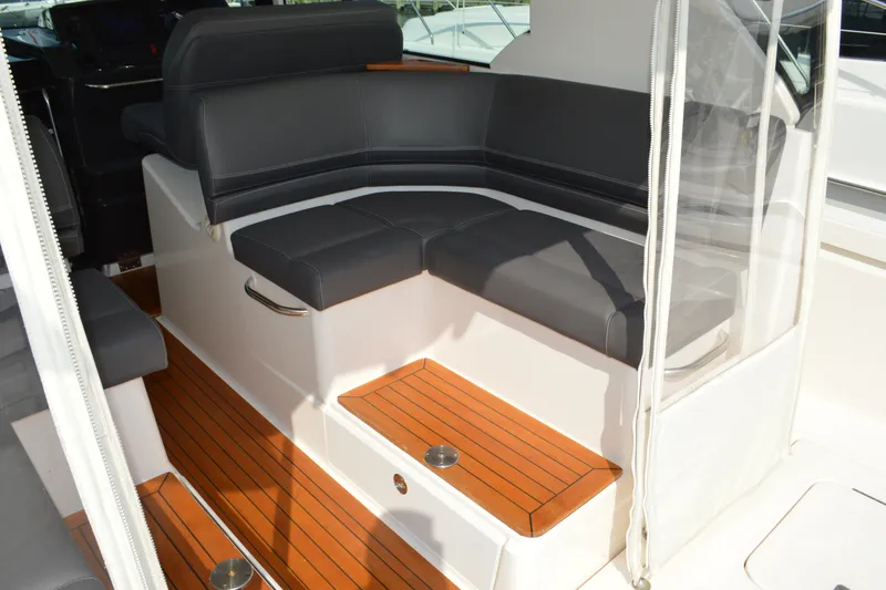Slide: The Image of 2016 Tiara Yachts Q44 interior with sleek seating and teak flooring. - 46