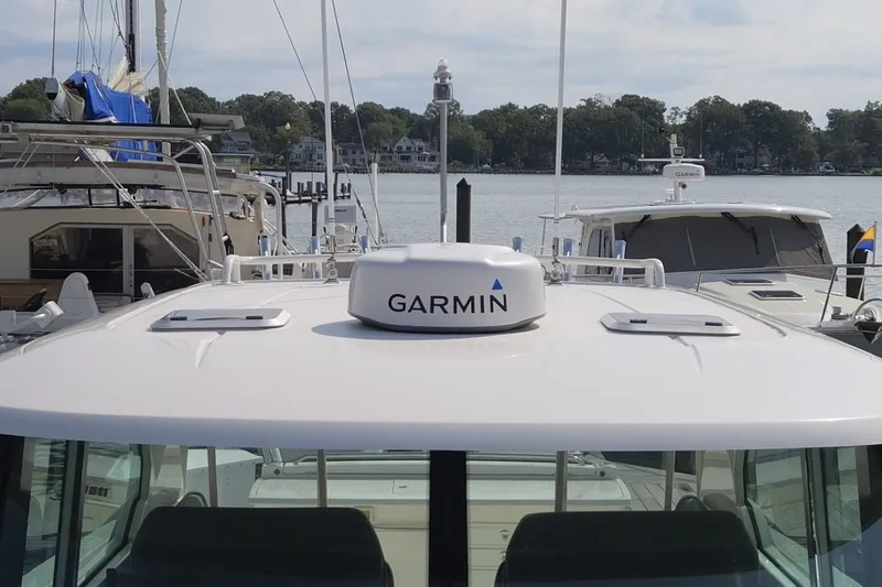 Slide: The Image of 2016 Tiara Yachts Q44 with Garmin equipment, docked at a marina. - 32