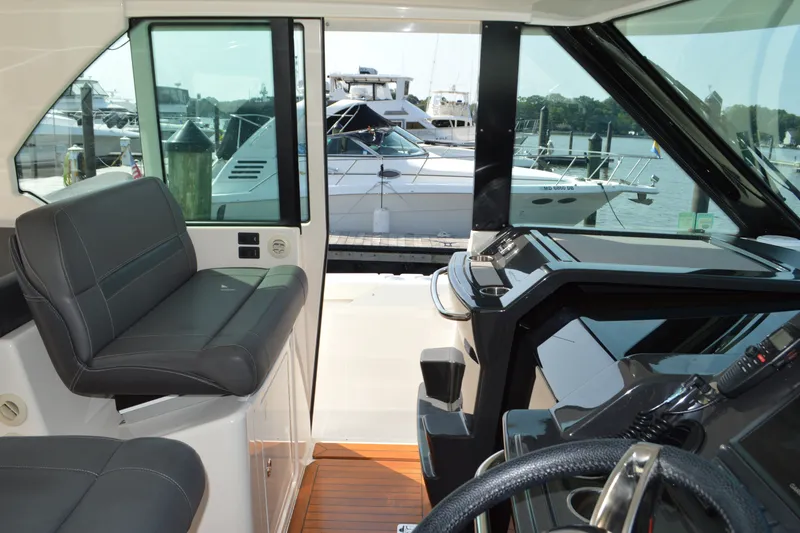 Slide: The Image of Interior view of 2016 Tiara Yachts Q44, showcasing helm and seating area. - 57