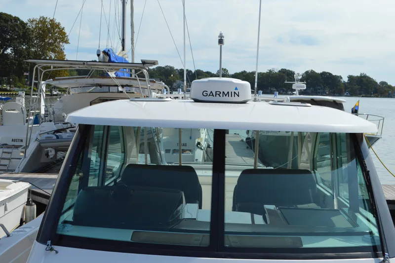 Slide: The Image of 2016 Tiara Yachts Q44 docked, featuring Garmin navigation system. - 31