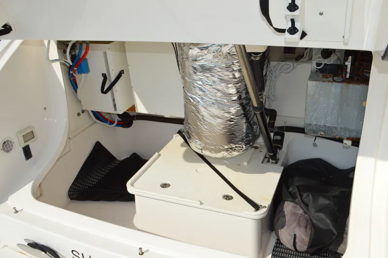 Slide: The Image of Engine compartment of 2016 Tiara Yachts Q44, showcasing mechanical components and wiring. - 16