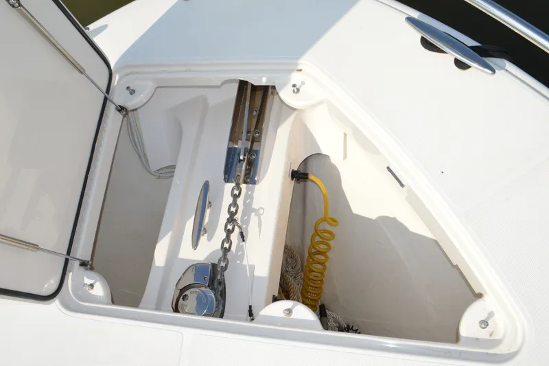 Slide: The Image of Open anchor locker on 2016 Tiara Yachts Q44, featuring chain and coiled hose. - 39
