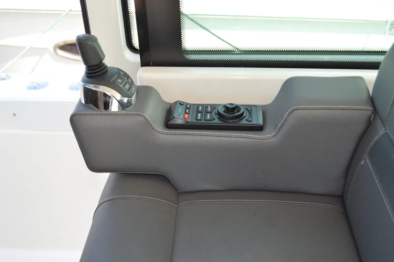 Slide: The Image of 2016 Tiara Yachts Q44 helm control panel with joystick and buttons. - 55